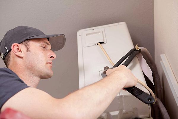 Tech installing AC unit