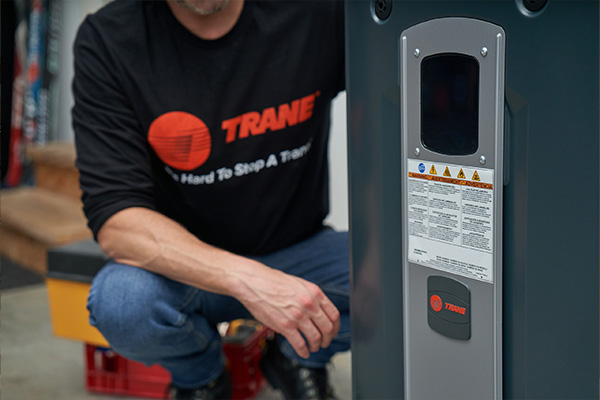 Trane rep with heating unit ready to install